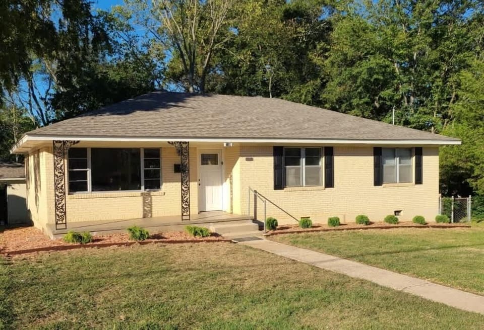 Front elevation of the house, with long driveway on the side for plenty of off-street parking.