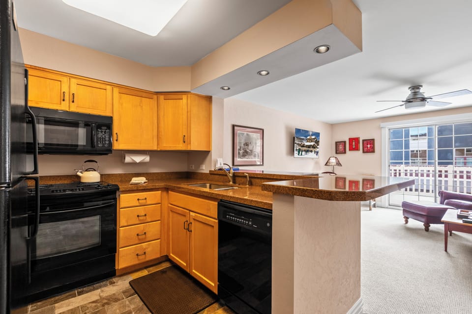 Resort Plaza 5051 offers a well-equipped kitchen with black appliances.