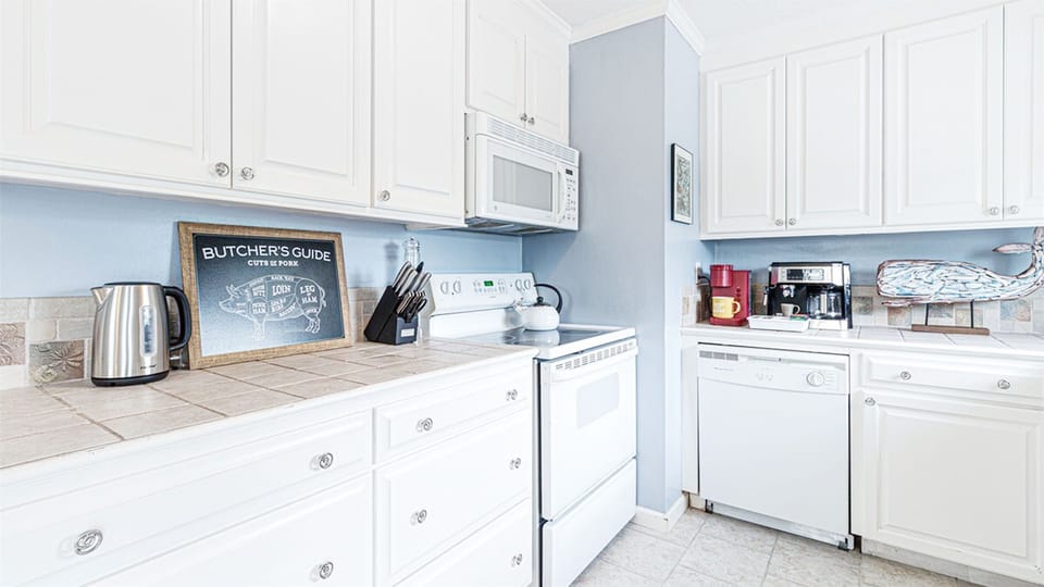 Open and bright kitchen, with all the appliances and utilities one could crave.