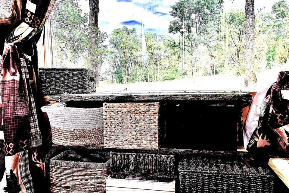 Various bins tucked beneath the bench for storage.