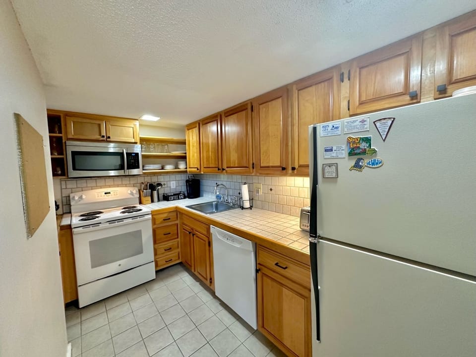 Fully stocked kitchen, dishwasher, oven/stove, and microwave.