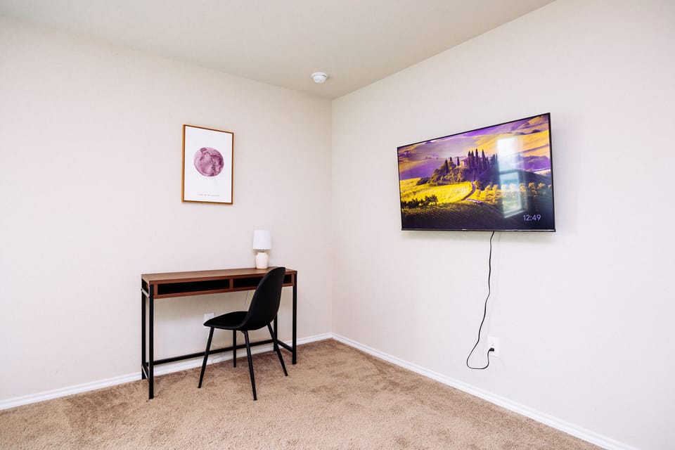 An office space and TV in master bedroom.
