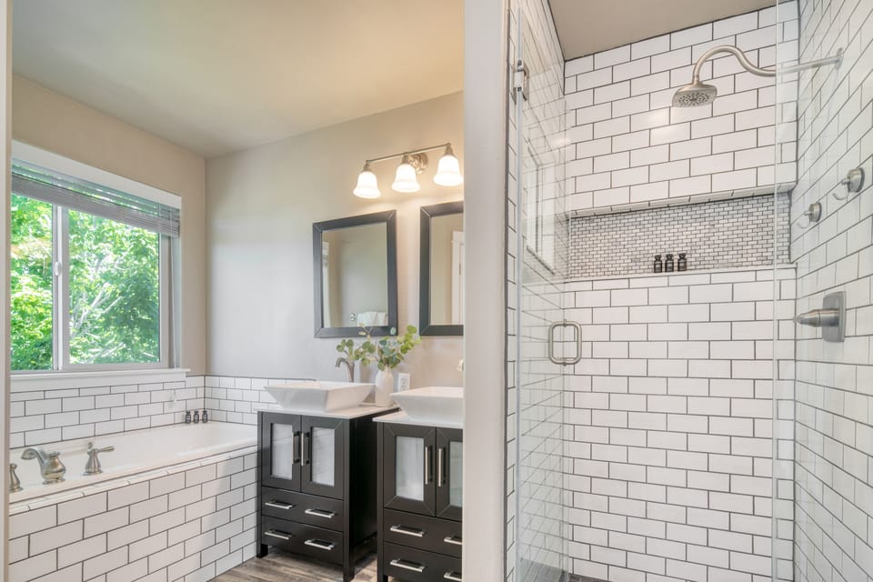 Primary bedroom's ensuite features two sinks and a separate shower and tub.