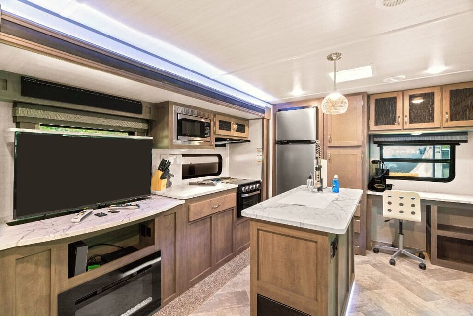 The Moto Ranch at Croom Vacation rentals The MX 1 bedroom 1 bath sleeps Three. 
kitchen, 3 burner propane stove, fridge/freezer, microwave, sink with cutting board cover. tv, and electric fireplace
