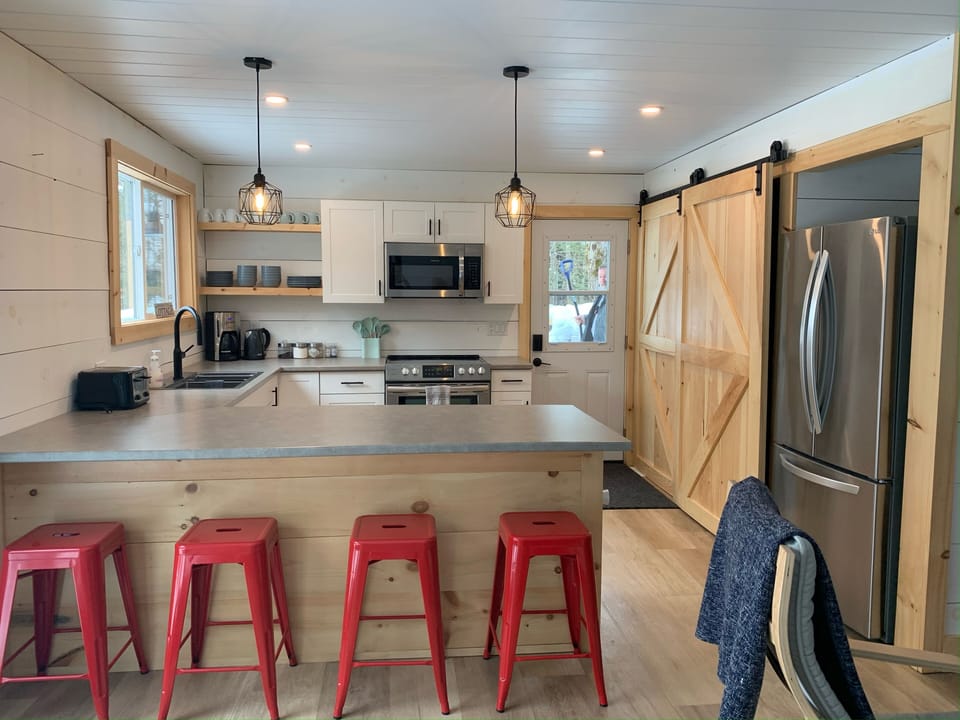 A fully-equipped kitchen with full-sized refrigerator.