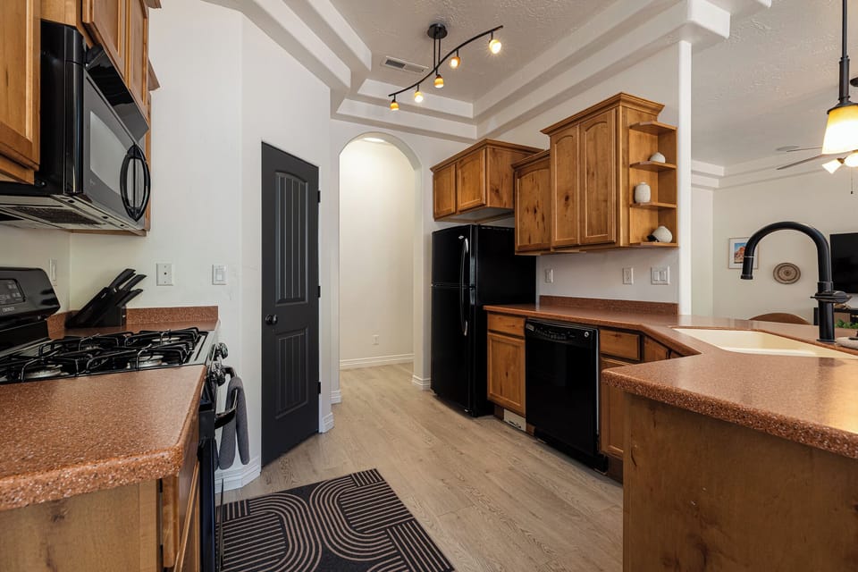 Fully stocked kitchen with full-sized appliances.