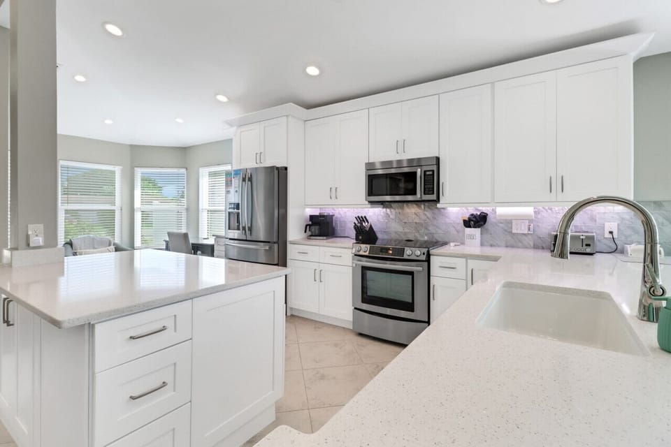 Top of the line kitchen with new cabinets and counters (2024), Jenn-Air appliances, Keurig Duo coffee pot, and large island.