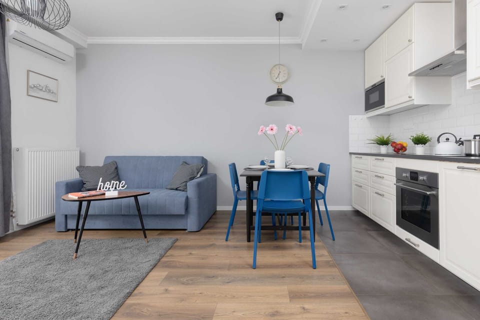 A wider view of the dining and kitchen area, emphasizing the open layout and modern furnishings.
