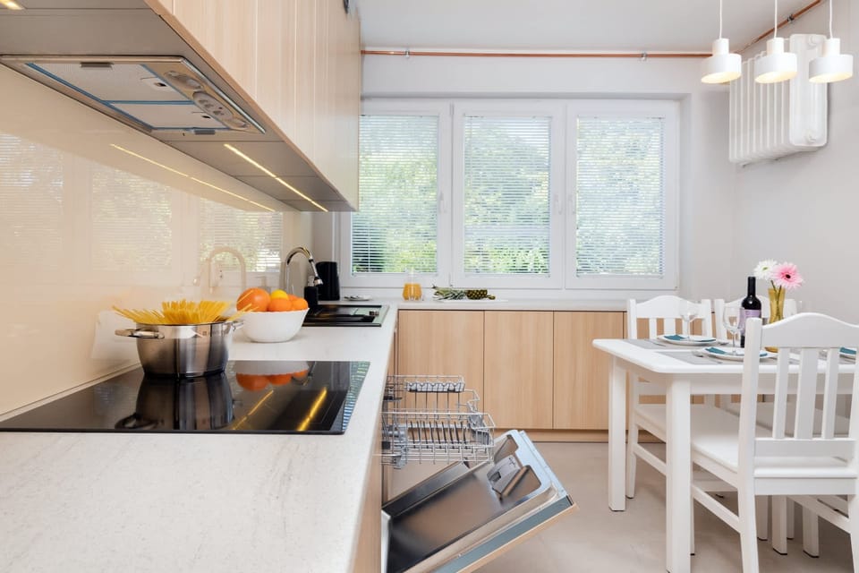 A close-up of the kitchen, with a well-organized layout and a dining table set for meals.
