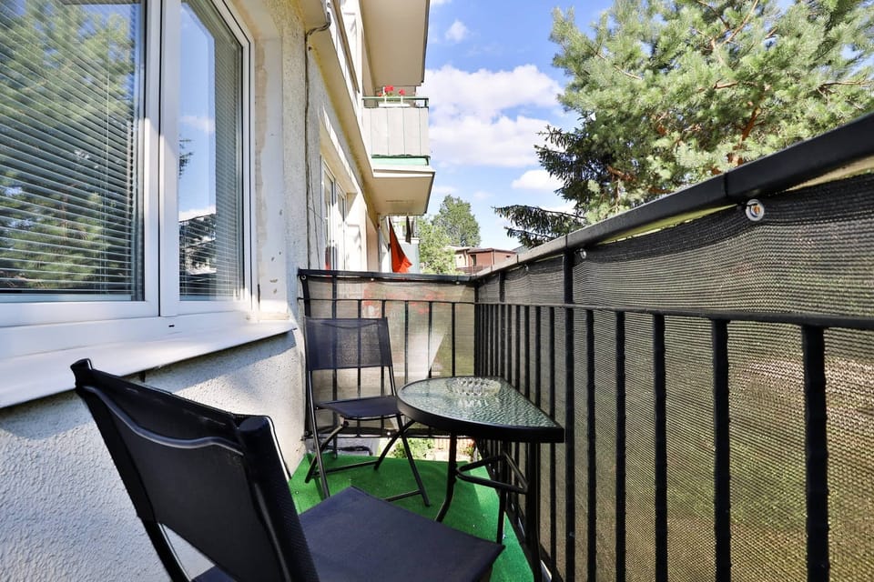 A small balcony with outdoor seating, offering a private space to enjoy the fresh air.
