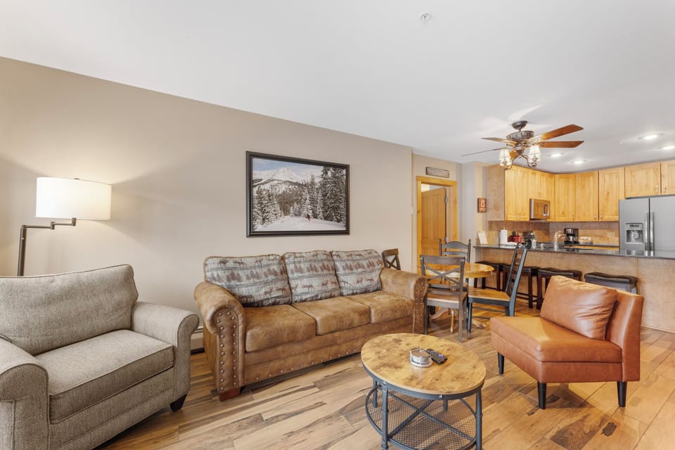 Unwind in your spacious open-concept living area with plush seating and a fully equipped kitchen ready for home-cooked meals.