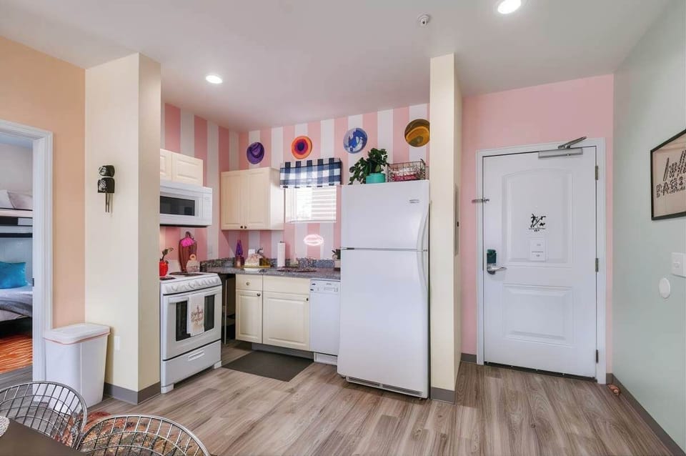 The pink-striped kitchen opens right onto the living room, so cooks stay in the mix while the crew gathers around. Start your East Nashville day here