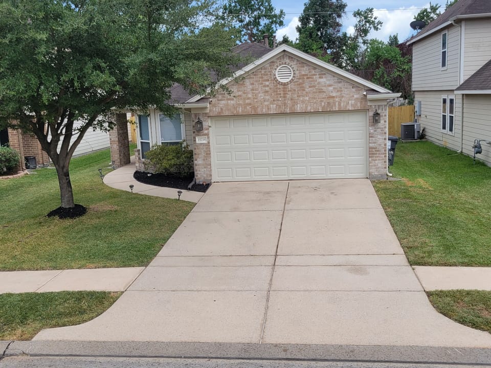 Front view of house has a 2 car driveway for parking and free street parking.