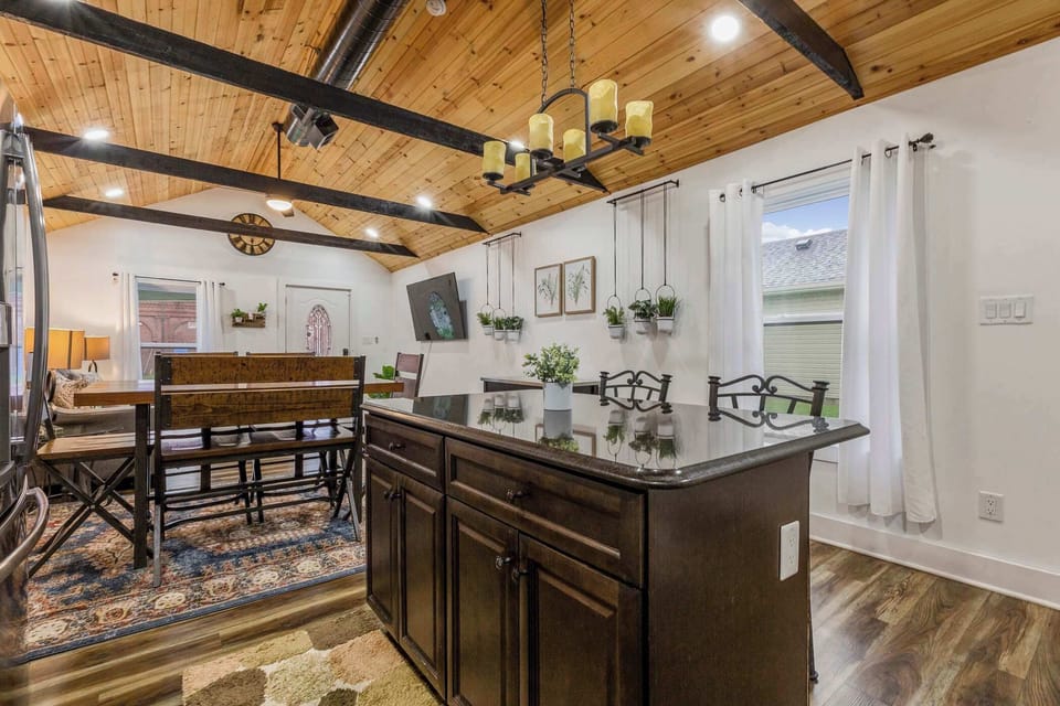 Gather around the dining table under warm wood-beam ceilings.