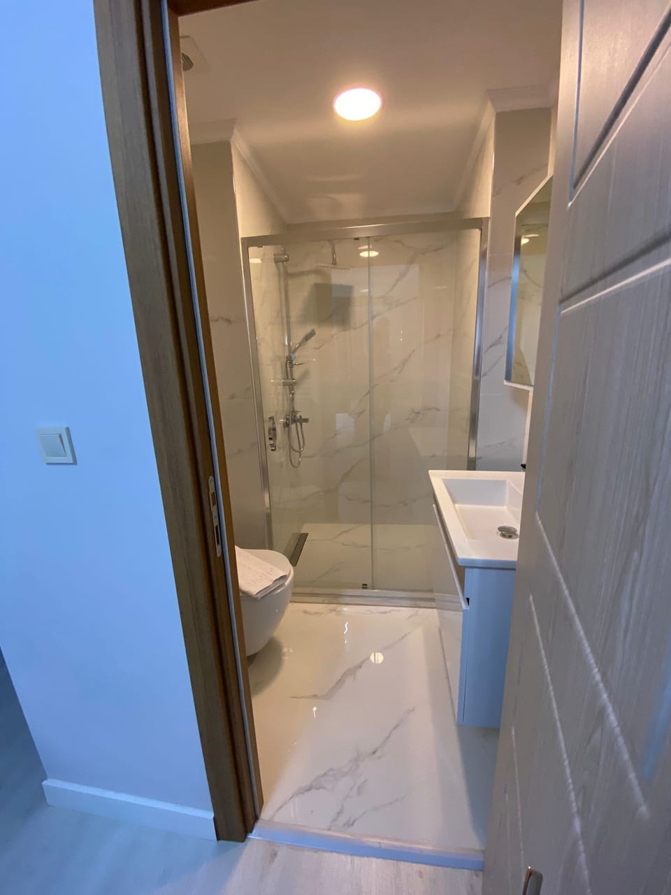 Shower, hair dryer, slippers, towels