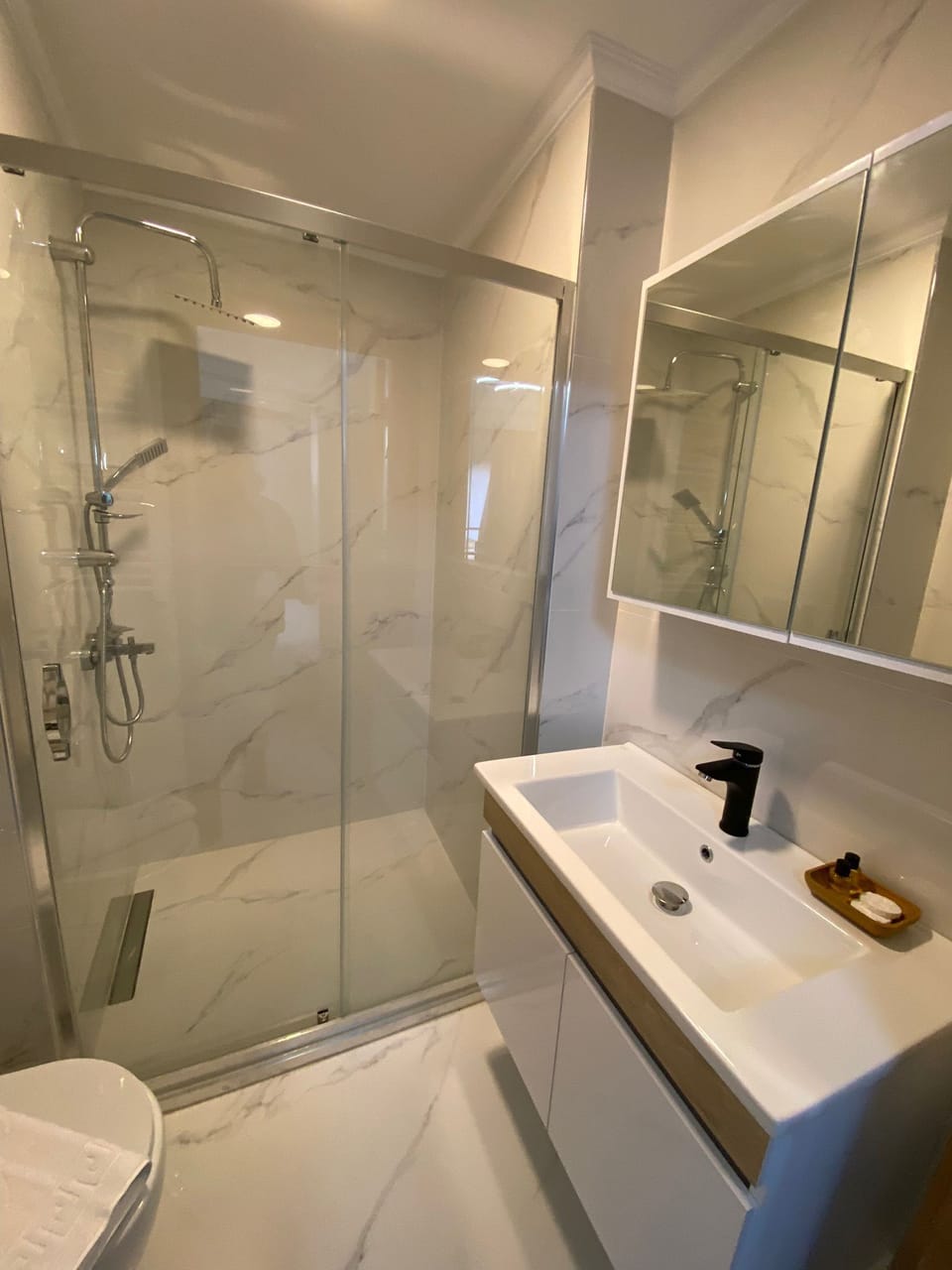 Shower, hair dryer, slippers, towels