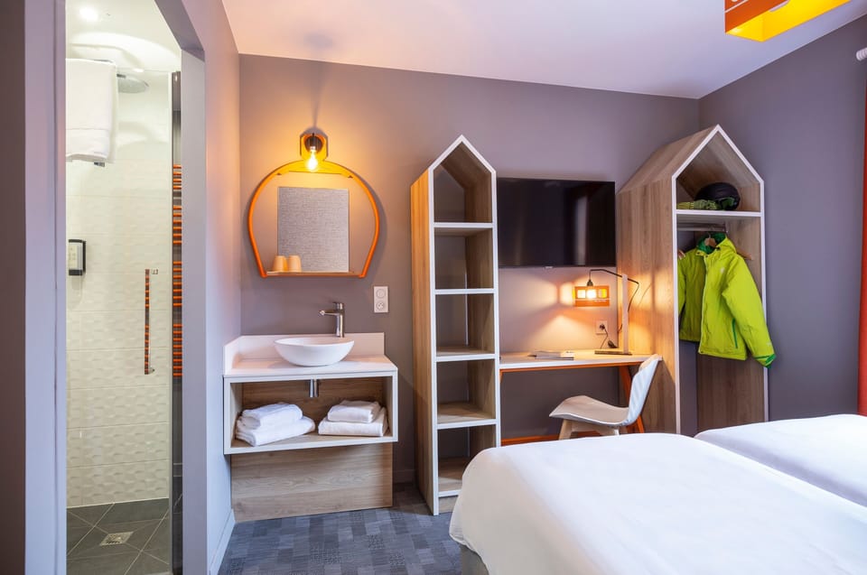 Our space features a flat-screen TV and a desk.