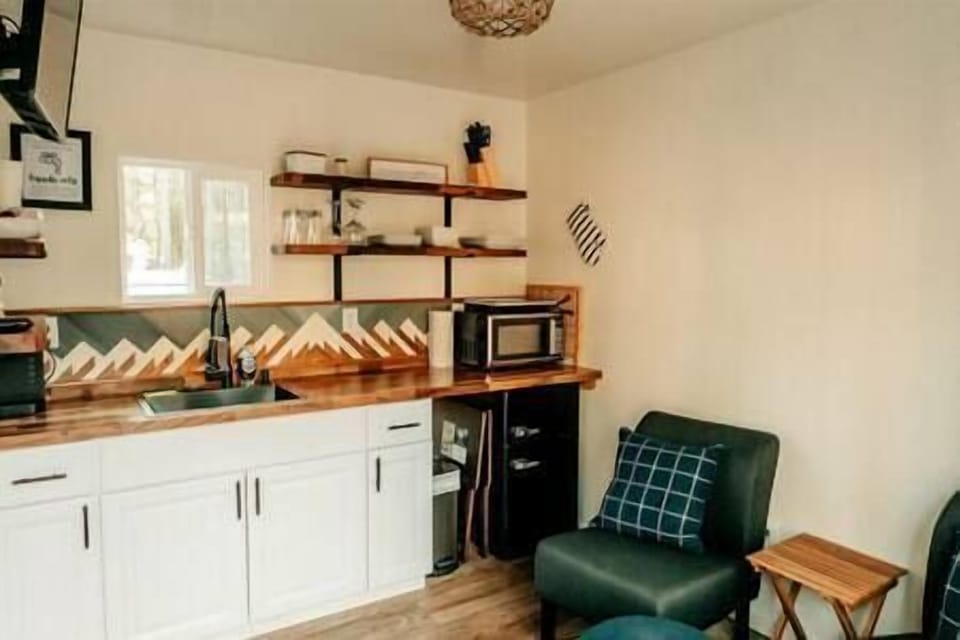 Kitchen with microwave, coffee pot w/coffee, air fryer, more and sitting area w/TV and tv trays