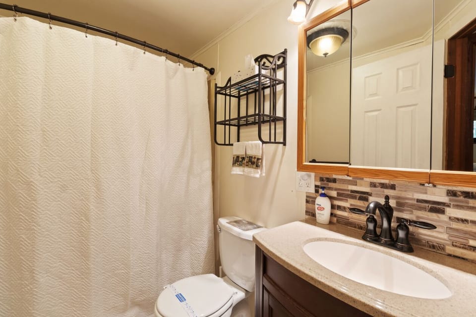 fully equipped bathroom, featuring a reliable and efficient toilet.