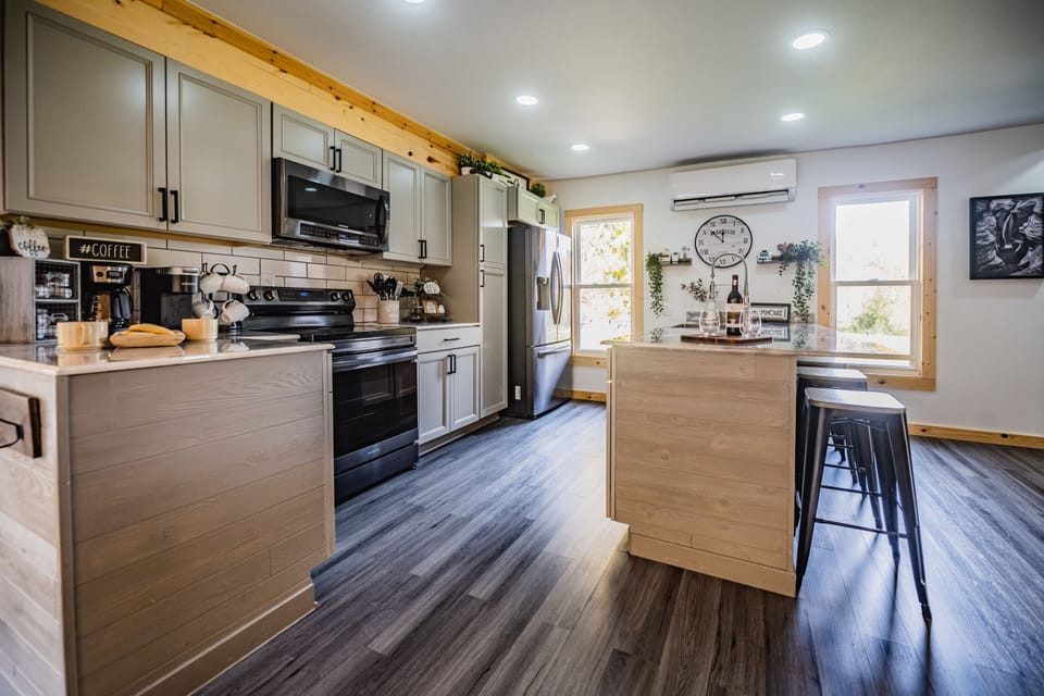 Whether you're brewing your first cup of coffee, preparing a family breakfast, or sharing a bottle of wine after a day of exploring Hocking Hills, this fully equipped kitchen has everything you need to feel right at home.

The spacious island offers the perfect place to gather, snack, and swap stories, while the open-concept layout keeps everyone connected. With modern appliances, ample counter space, and thoughtful touches throughout, cooking here is just as enjoyable as dining together.