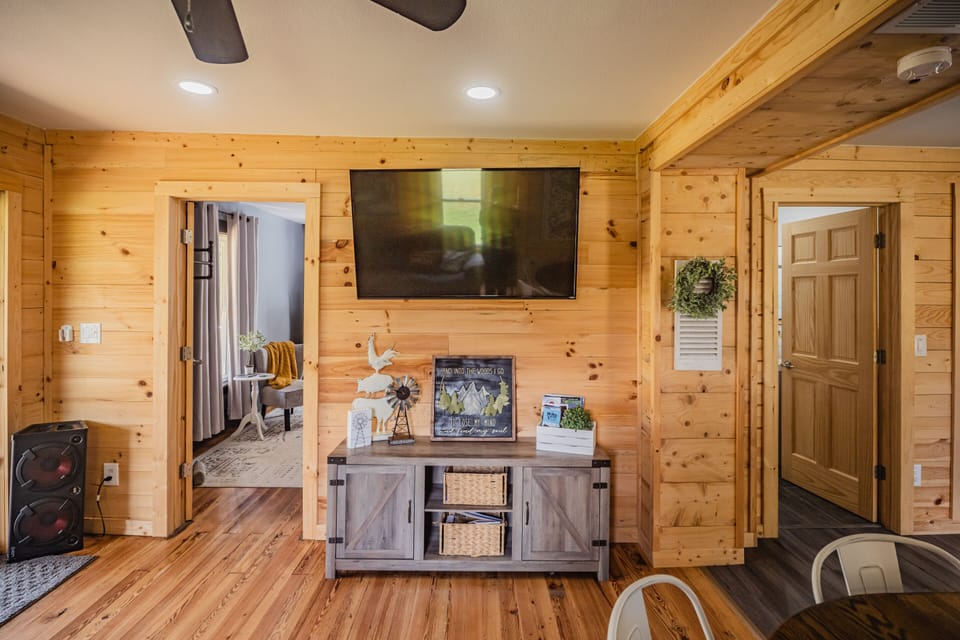 This cozy living room is the perfect place to unwind after a day of exploring Hocking Hills. Gather around the 50-inch Smart TV and stream your favorite shows with YouTube TV, Netflix, and Hulu, or settle in for a family movie night on the comfortable seating.

Looking for some unplugged fun? You'll find a selection of games for both kids and adults conveniently stored in the TV stand, making rainy days, evenings in, and family competitions just as memorable as your outdoor adventures.

Whether you're cheering on your favorite team, watching a movie, or laughing over a board game, this space was designed for making memories together.