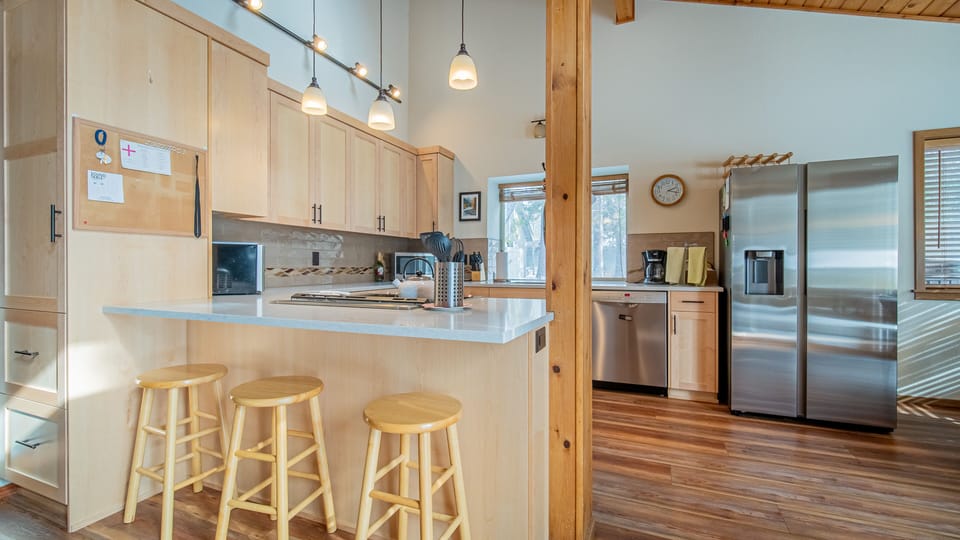 Your spacious kitchen awaits with gleaming countertops, modern appliances, and a cozy breakfast bar perfect for morning coffee.