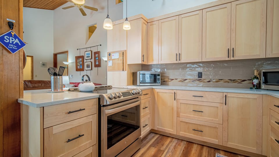 Your fully-equipped kitchen awaits with modern appliances and warm wood cabinetry, perfect for preparing memorable meals during your stay.