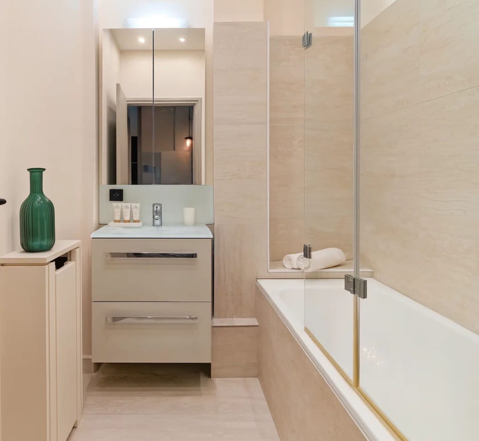 A fully equipped bathroom with shower and bath
