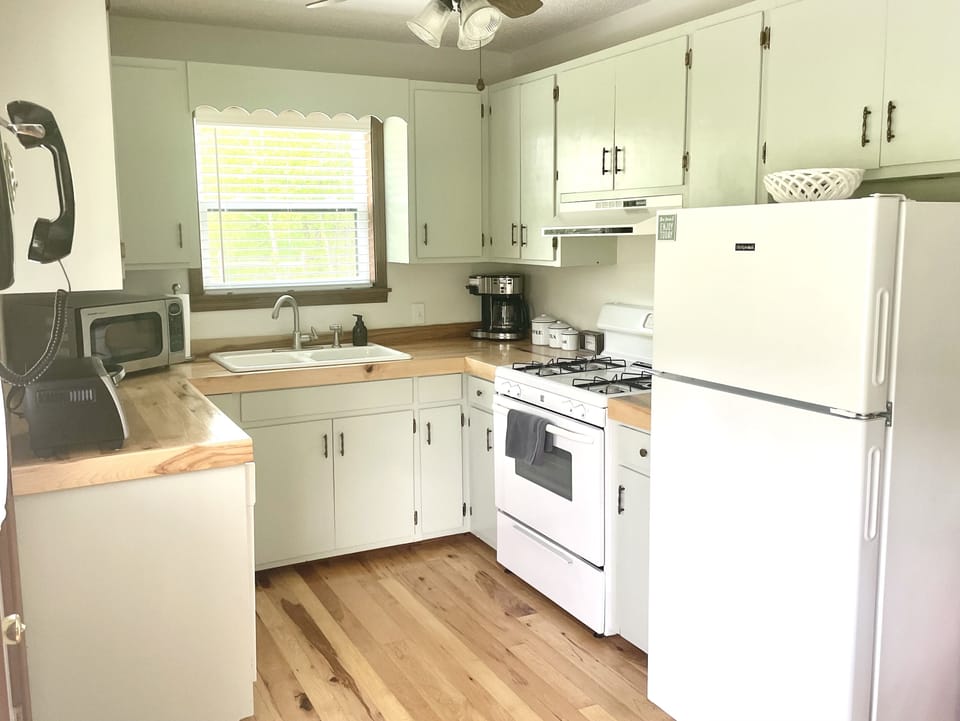 Kitchen features gas stove/oven, microwave, toaster oven, refrigerator.