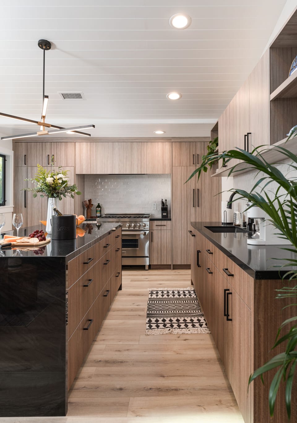 Stainless steel appliances, custom cabinetry, and a fully stocked kitchen await.