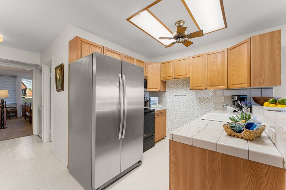 The fully stocked open-concept kitchen is a culinary delight, ready for creating delicious meals with a dining table for four nearby.