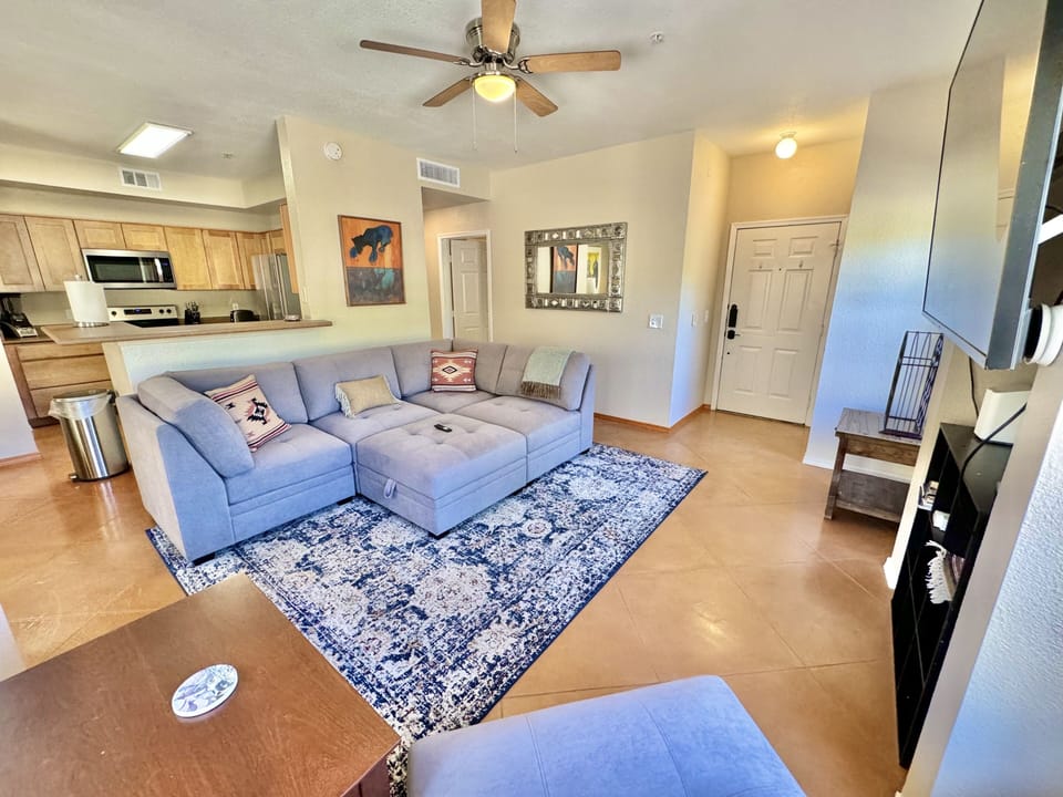 Living room with comfy sectional and huge smart TV