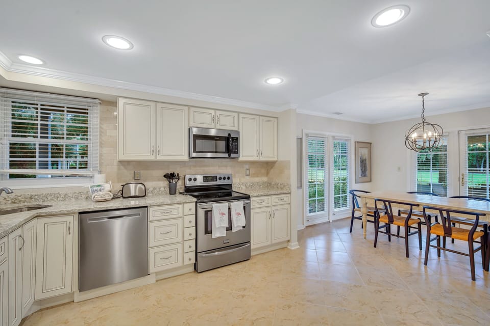 Fully stocked kitchen with all stainless steel appliances.