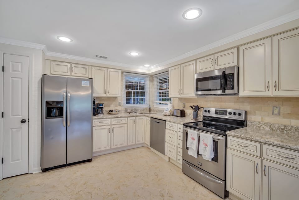 Fully stocked kitchen with all stainless steel appliances.