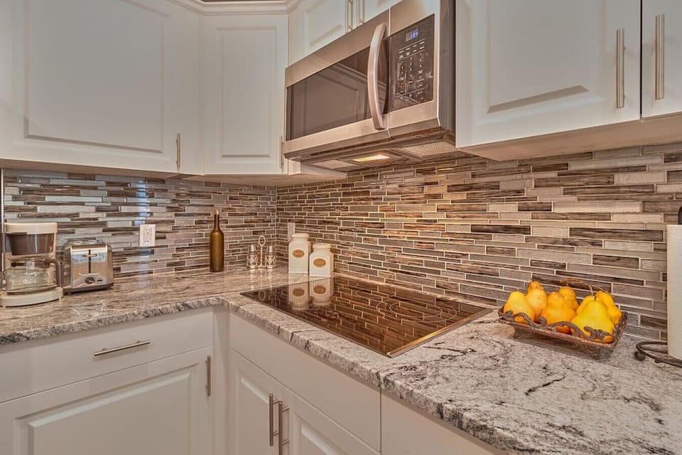 In addition to the microwave, the kitchen features a coffee maker and a toaster.