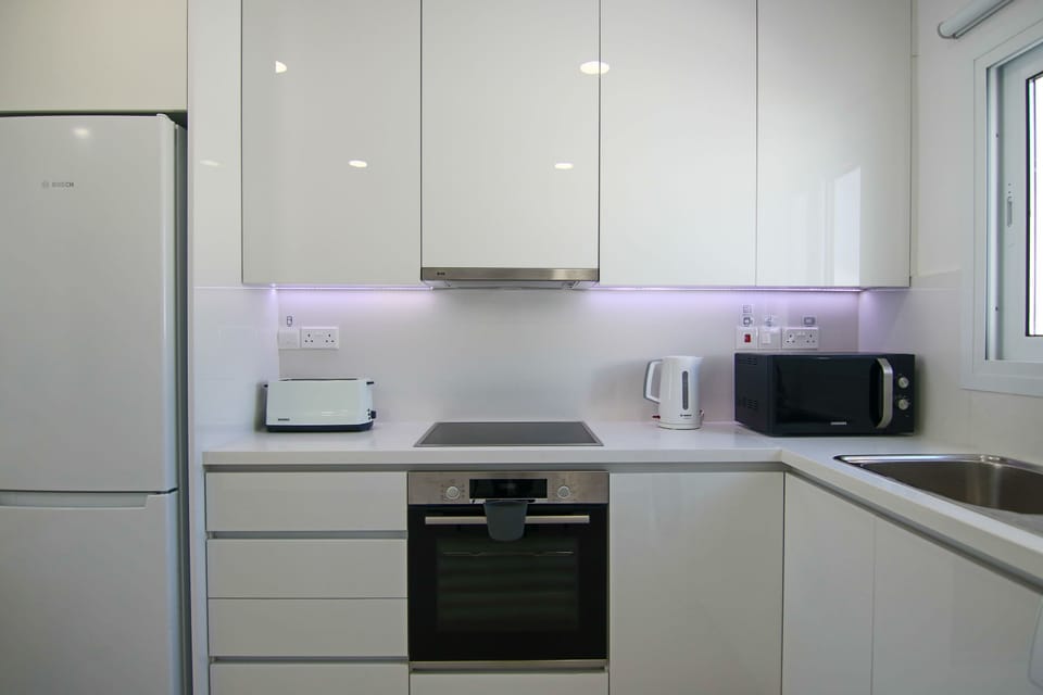 Luxury Apartment | Private kitchen | Fridge, coffee/tea maker, highchair, dining tables