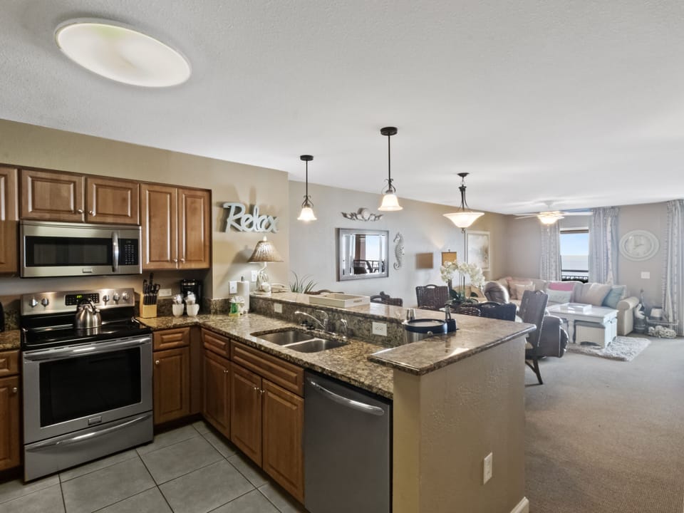 Your fully equipped kitchen flows seamlessly into the comfortable living area, perfect for preparing meals while staying connected with family.