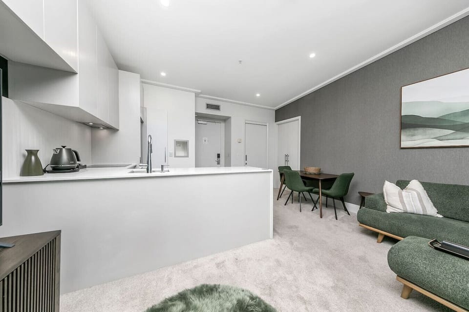 The open-plan heart of this Sebel penthouse flows effortlessly from kitchen to dining to lounge -- a harbour-view haven designed for comfort on the Viaduct Marina.