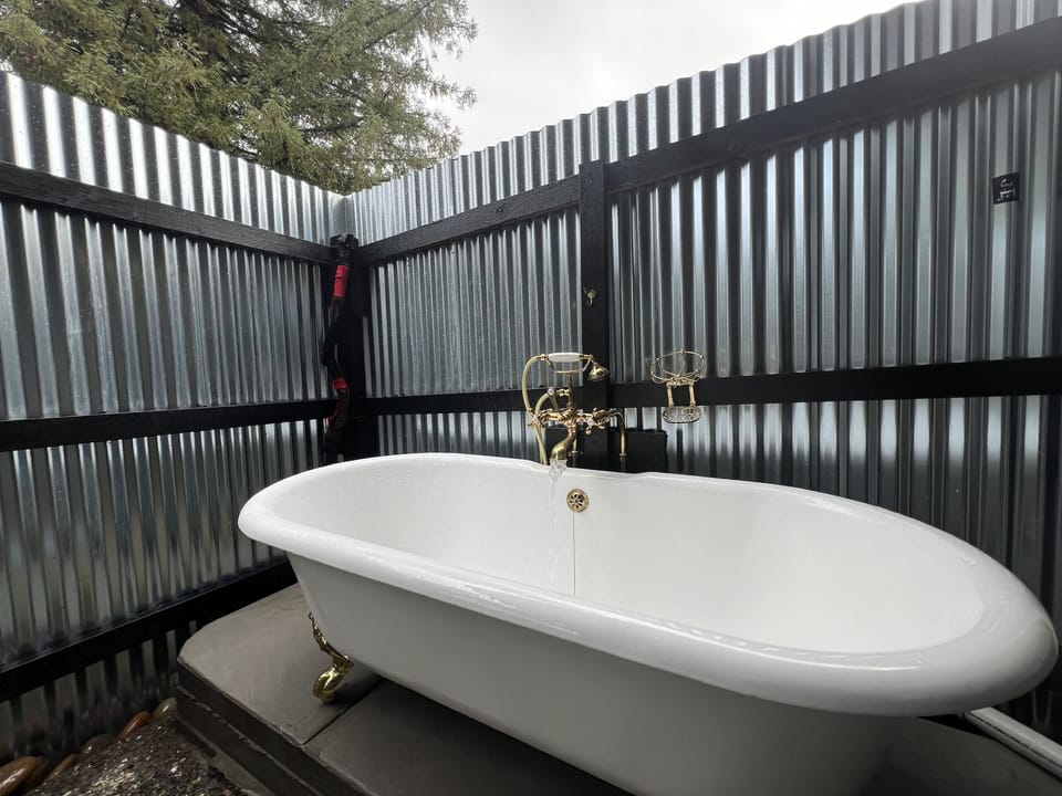 An outside clawfoot hot tub for soaking under the stars.