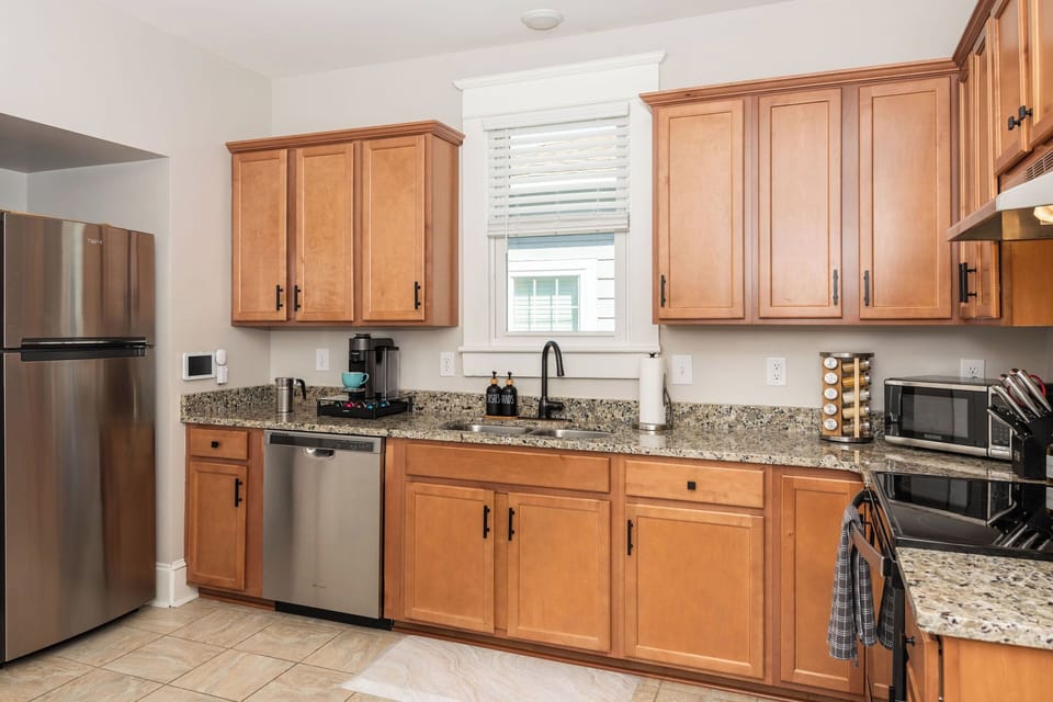 Full Size Kitchen with fridge, dishwasher, stove, oven, microwave, and coffee machine. (1)