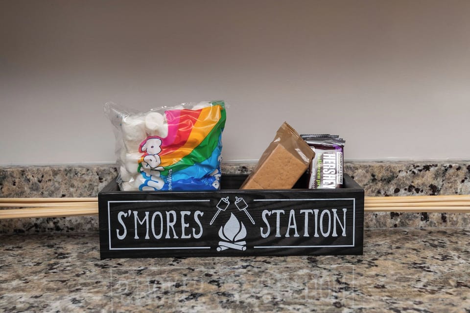 S'Mores Station with chocolate bars, graham crackers, marshmallows, and disposable roasting sticks. 