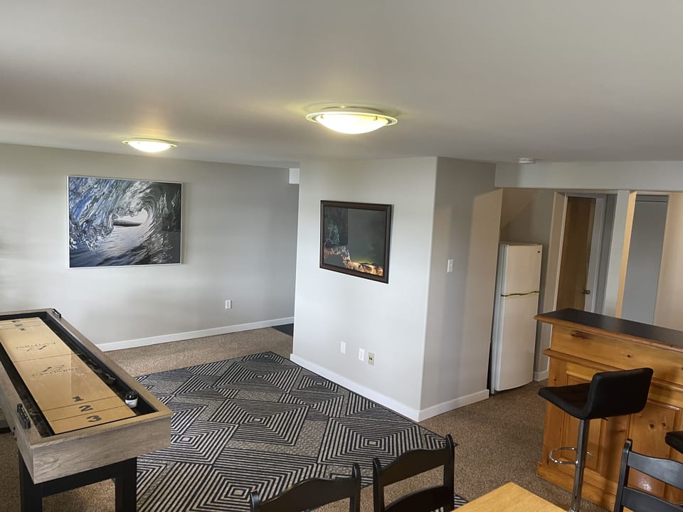 Recreation/Games room with cards table bar and fridge. 