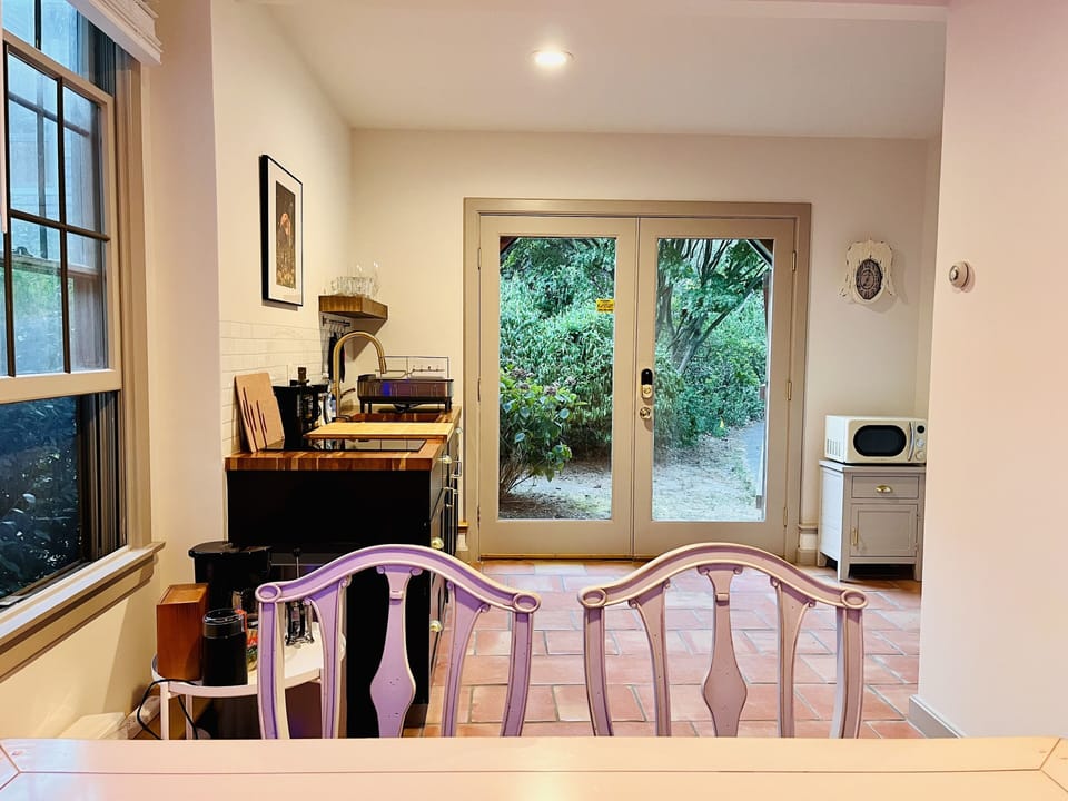 1ST FLOOR: Kitchenette with view of front entrance and microwave
