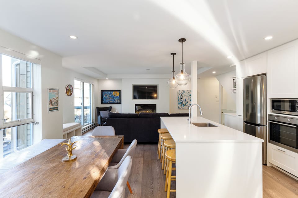 Kitchen/Dining Room: Spacious and open for family meals, bar seating, modern and bright, large dining table seating 7-8