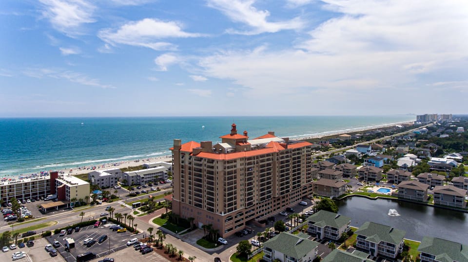 Aerial view of beachfront resort property with direct beach access and waterfront location.