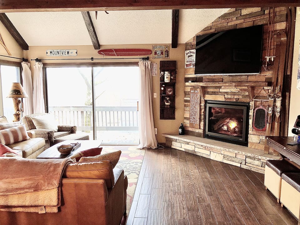 Spacious living room area with gas powered fire place, 65" Smart Tv and AppleTV