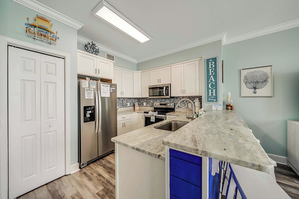 The fully equipped kitchen features granite countertops, stainless-steel appliances, and has everything you need to prepare meals for family & friends.