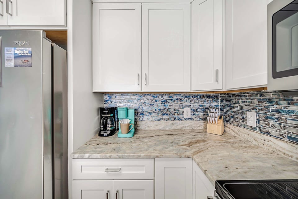 The fully equipped kitchen features granite countertops, stainless-steel appliances, and has everything you need to prepare meals for family & friends.