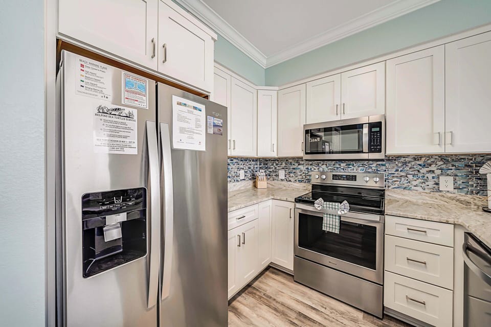 The fully equipped kitchen features granite countertops, stainless-steel appliances, and has everything you need to prepare meals for family & friends.