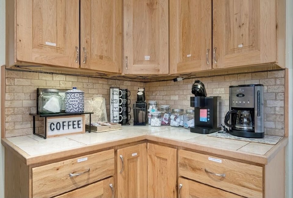 Coffee station complete with drip coffee maker, keurig, tea, cream and coffee